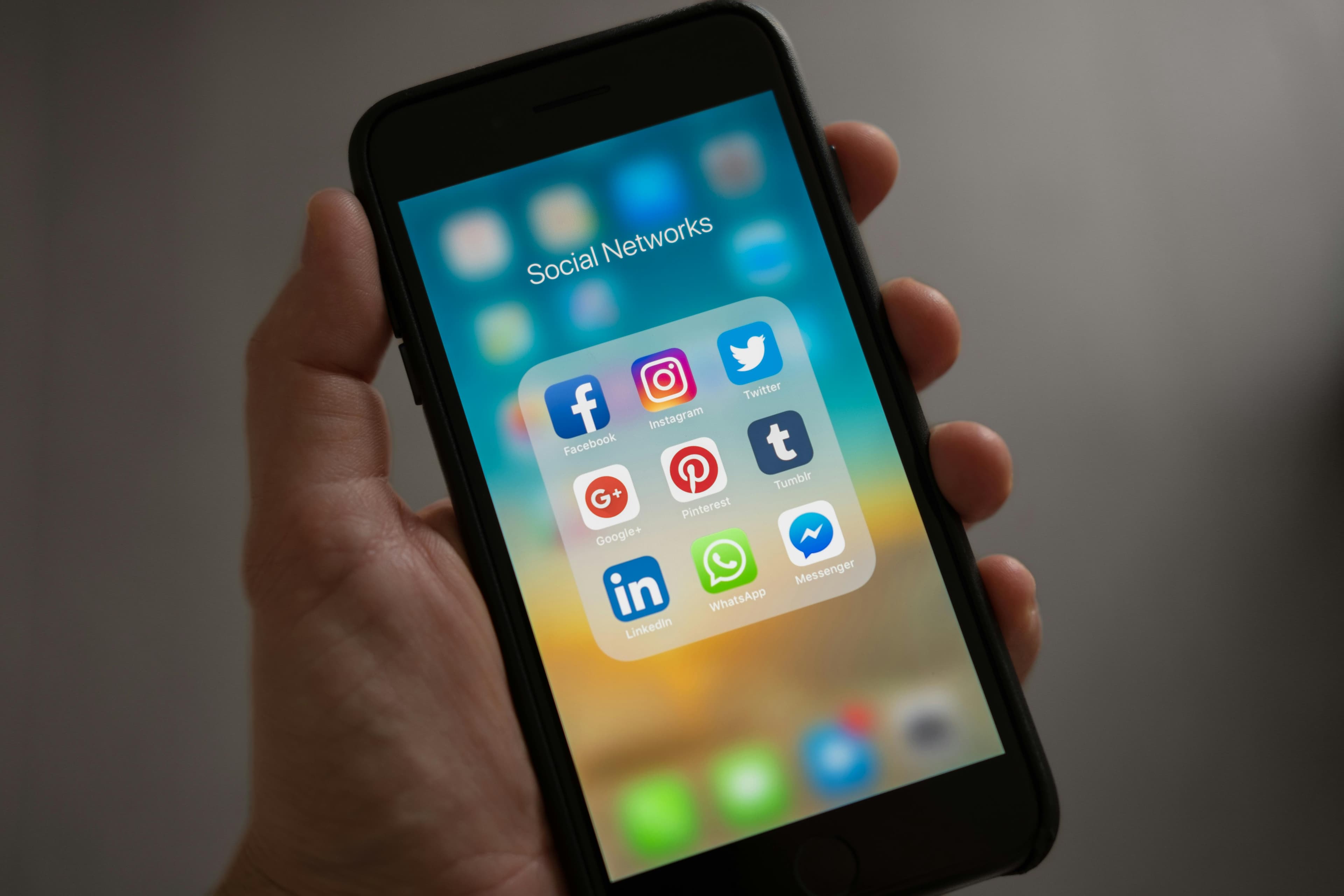 Person overwhelmed by phone notifications and social media apps